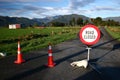 Road closed sign and traffic cones on country road