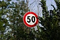 Circular road sign limiting the speed to 50 kilometers per hour Italy, Europe Royalty Free Stock Photo