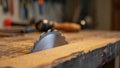 Circular saw blade positioned on a wooden workbench in a workshop setting Royalty Free Stock Photo