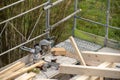 Circular saw from carpenter on a rafter of a new wooden roof