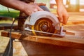 Circular Saw. Carpenter Using Circular Saw for wood beam Royalty Free Stock Photo