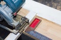 Circular saw cutting wood and iron ruler Royalty Free Stock Photo