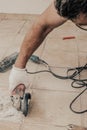 A circular saw. A man sawing ceramic tiles. Worker sawing a tile on a circular saw. Construction works. Selective focus