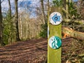 Circular signs on a weathered wooden post mark the way of a bridle path with walkers welcome.