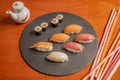 circular slate tray with assorted tuna nigiri, butterfish, Norwegian salmon and prawns and salmon mak