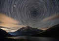 Circular star trails create a mesmerizing spiral pattern in the night sky, captured through Royalty Free Stock Photo