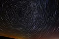 Circular star trails in the sky with a tint of city light from far away