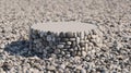 A circular stone podium displayed on a pebble beach surface for product presentation Royalty Free Stock Photo