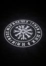 Circular symbol featuring Nordic runes and a central Vegvisir, a Viking compass. The Royalty Free Stock Photo
