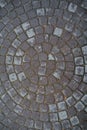 Circular texture of square stone floor. Urban cobble paving laid out of circles