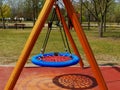 Empty playground. no kids due to Social Distancing. round vinyl swing detail