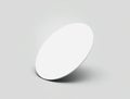 Circular white object with smooth surface resting on a gray background in a minimalist setting Royalty Free Stock Photo
