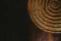 Circular wicker mat on wooden floor background, view from above Royalty Free Stock Photo