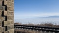 Circum-Baikal railway in winter and spring. Lake Baikal in ice, rails, part of the old tunnel wall in the frame Royalty Free Stock Photo