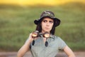 Circumspect Explorer Girl with Camouflage Hat and Binoculars