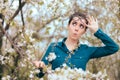 Funny Girl Surrounded by Blossoming Trees Afraid of Allergies