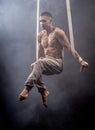 Circus artist on the aerial straps man