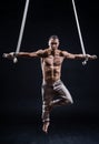 Circus artist on the aerial straps man