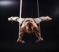 Circus artist on the aerial straps man