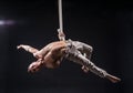 Circus artist on the aerial straps man