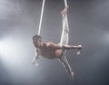 Circus artist on the aerial straps man