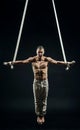 Circus artist on the aerial straps