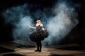 funny ballerina in a black dress and smoke