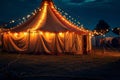 Circus tent with illuminations lights at night.