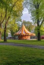 circus tent in a park with childrens playground nearby