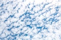 Cirrocumulus clouds as small rounded puffs appear in long rows h