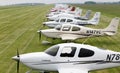 Cirrus aircraft series in the meadow in the background Airbus landing on a concrete runway. 22 May 2010. Airport Kbely, Prague.