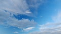 Cirrus clouds flying slowly on beautiful blue sky horizon background. Timelapse. Royalty Free Stock Photo