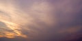 Cirrus clouds tinted pink by the sun at sunset over a calm blue ocean, Royalty Free Stock Photo