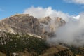The Cirspitzen, Cime Cir, covered in clouds while the Sky is Blue. The DOlomites in Fall Royalty Free Stock Photo