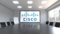 Cisco Systems logo on the screen in a meeting room. Editorial 3D rendering