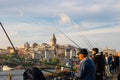 Citizens of Istanbul. Local people fishing with fishing rods on Galata Bridge Royalty Free Stock Photo