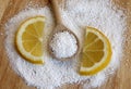 Citric acid in wooden spoon with lemon Royalty Free Stock Photo