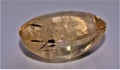 Citrine with rutile inclusions in a cabochon shape