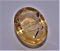 Citrine with rutile inclusions in a cabochon shape