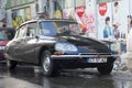 Retro Citroen car parked in front of a supermarket