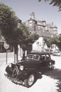 Citroen traction avant parked near a medieval castle in Estaing, France