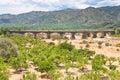 Citrous garden and bridge in dry riverbed Royalty Free Stock Photo