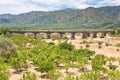 Citrous garden and bridge in dry riverbed