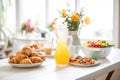 citrus agua fresca carafe amidst a brunch spread with pastries