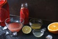 Citrus cocktail in the different glass dish on the dark stone background