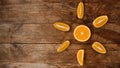 Citrus composition, orange in the shape of sun on the wooden background.