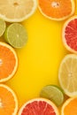 Citrus frame. Mix flat lay lemon, orange, lime, grapefruit on yellow.
