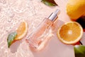 Citrus Freshness Perfume Bottle in Rippling Water with Oranges Royalty Free Stock Photo
