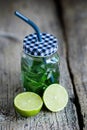 Citrus fruit and herbs infused sassi water for detox or dieting in glass bottles on wooden board, dark background Royalty Free Stock Photo