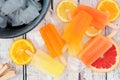 Citrus fruit ice pops, above scene on rustic wood Royalty Free Stock Photo